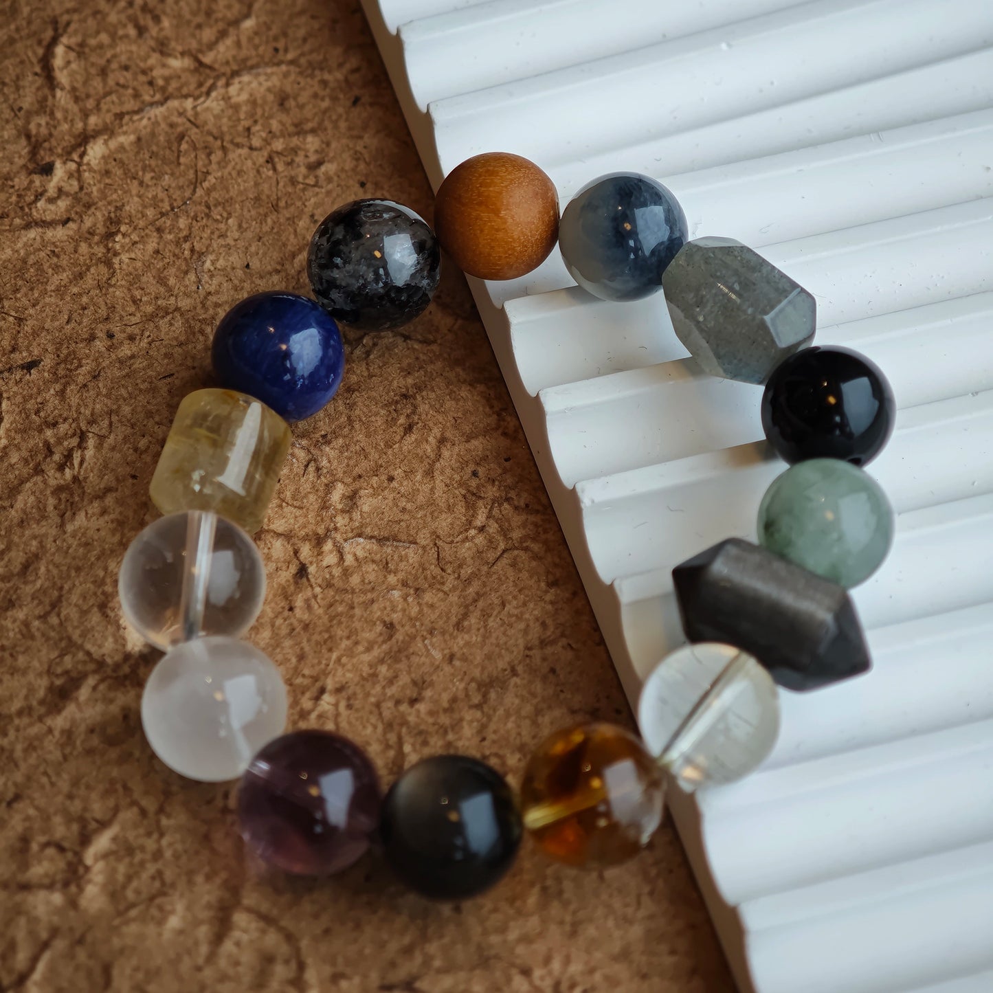 A serene blend of rutile, white phantom, citrine, amethyst, moonstone and silver obsidian for understated mystique.