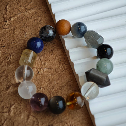 A serene blend of rutile, white phantom, citrine, amethyst, moonstone and silver obsidian for understated mystique.