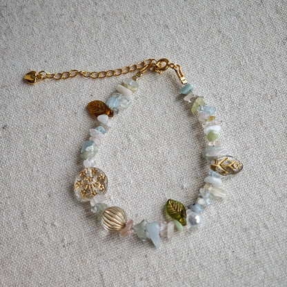 Consist of milky white and pale blue glass beads and shimmering crystal fragments, this beaded bracelet glows like sunlight dancing on icy shores.