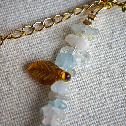 Consist of milky white and pale blue glass beads and shimmering crystal fragments, this beaded bracelet glows like sunlight dancing on icy shores.