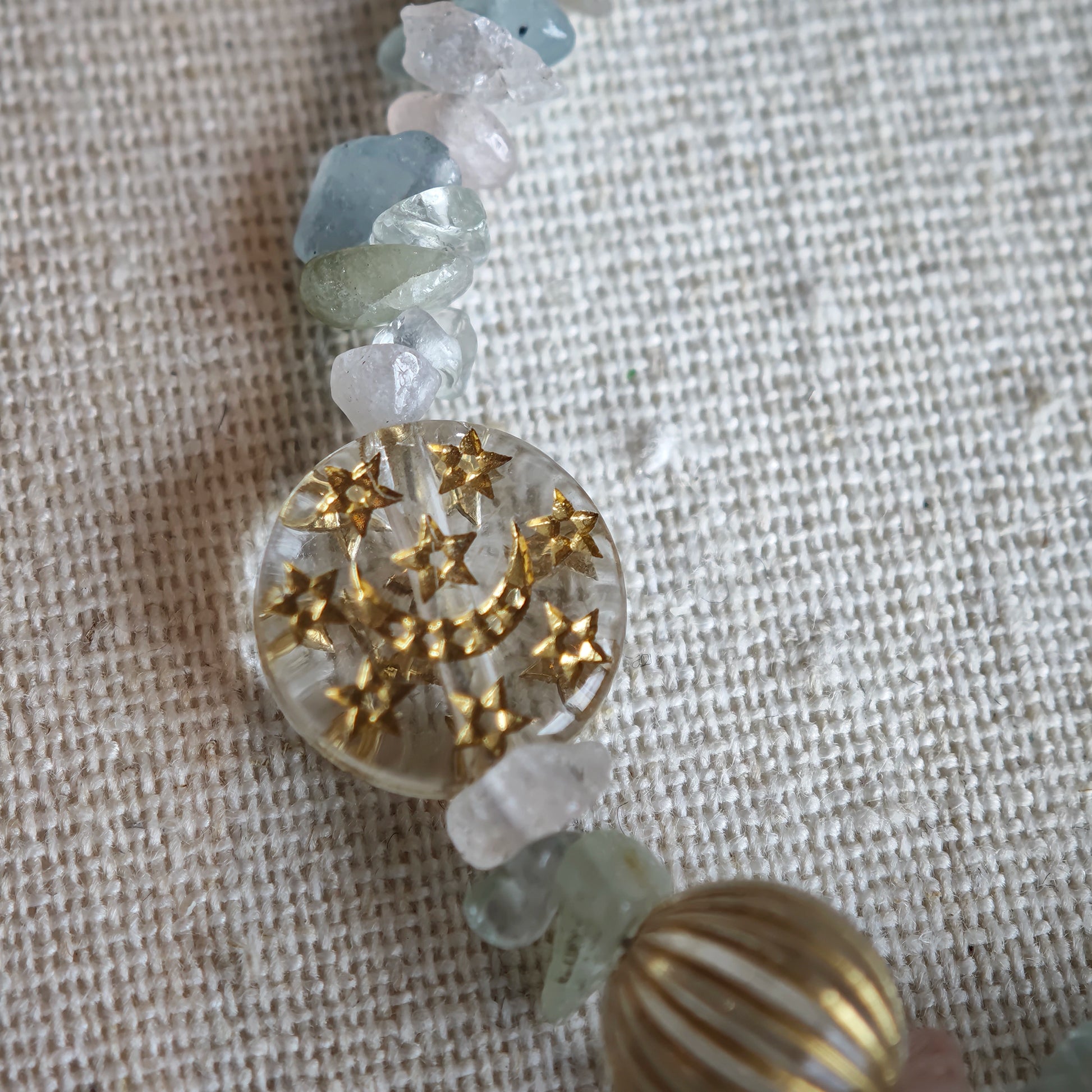 Consist of milky white and pale blue glass beads and shimmering crystal fragments, this beaded bracelet glows like sunlight dancing on icy shores.