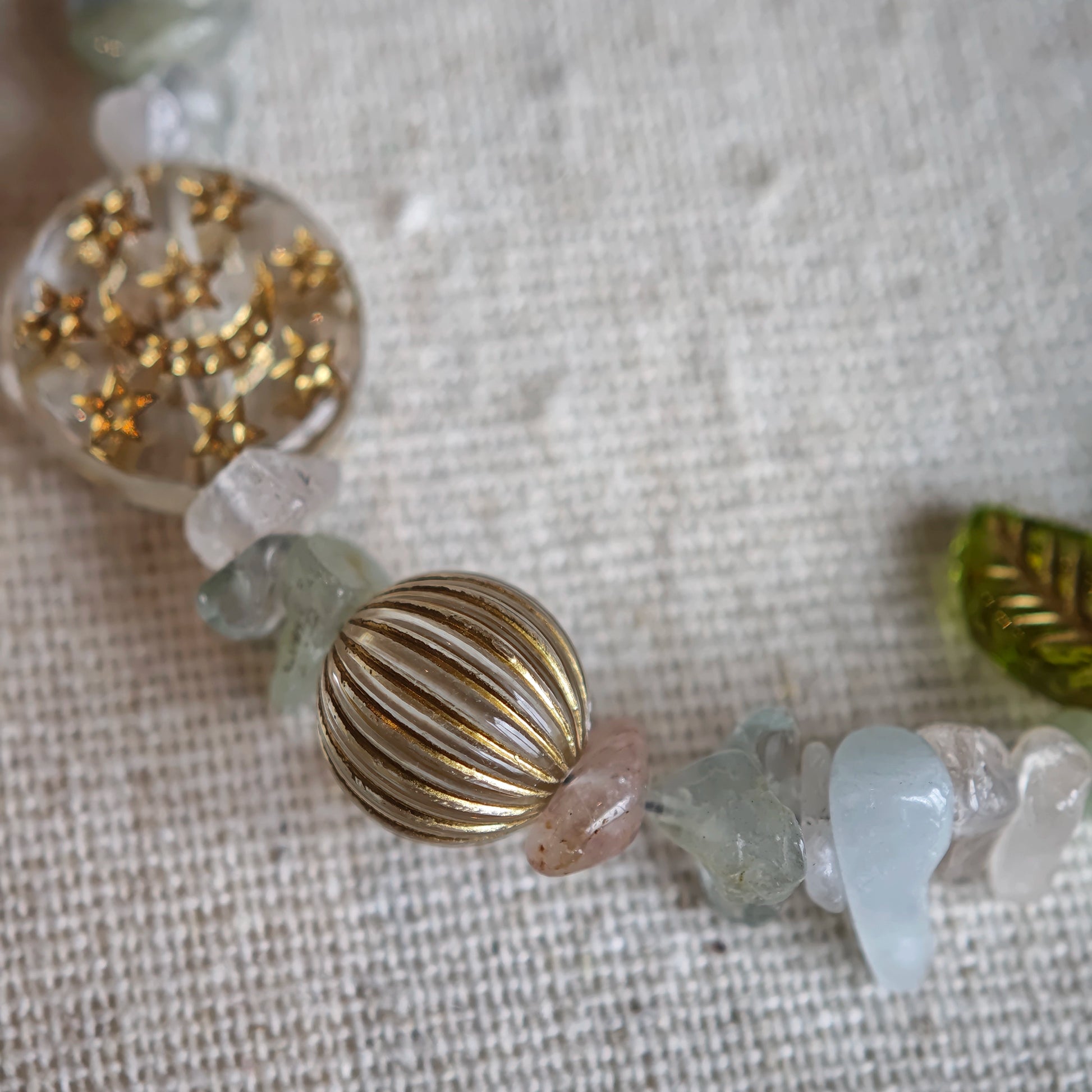 Consist of milky white and pale blue glass beads and shimmering crystal fragments, this beaded bracelet glows like sunlight dancing on icy shores.