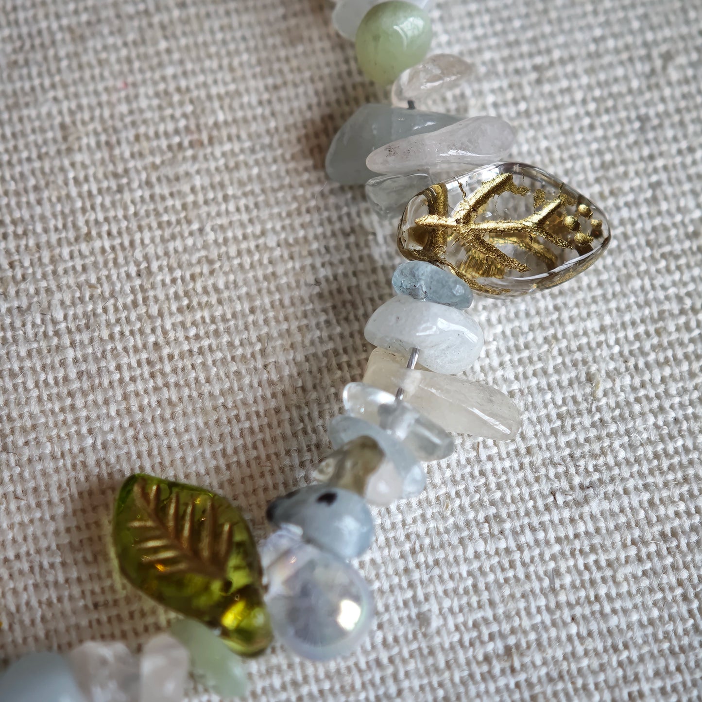 Consist of milky white and pale blue glass beads and shimmering crystal fragments, this beaded bracelet glows like sunlight dancing on icy shores.