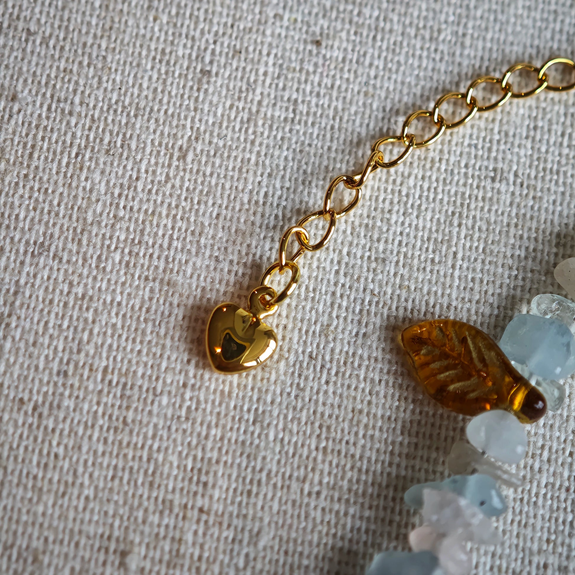 Consist of milky white and pale blue glass beads and shimmering crystal fragments, this beaded bracelet glows like sunlight dancing on icy shores.