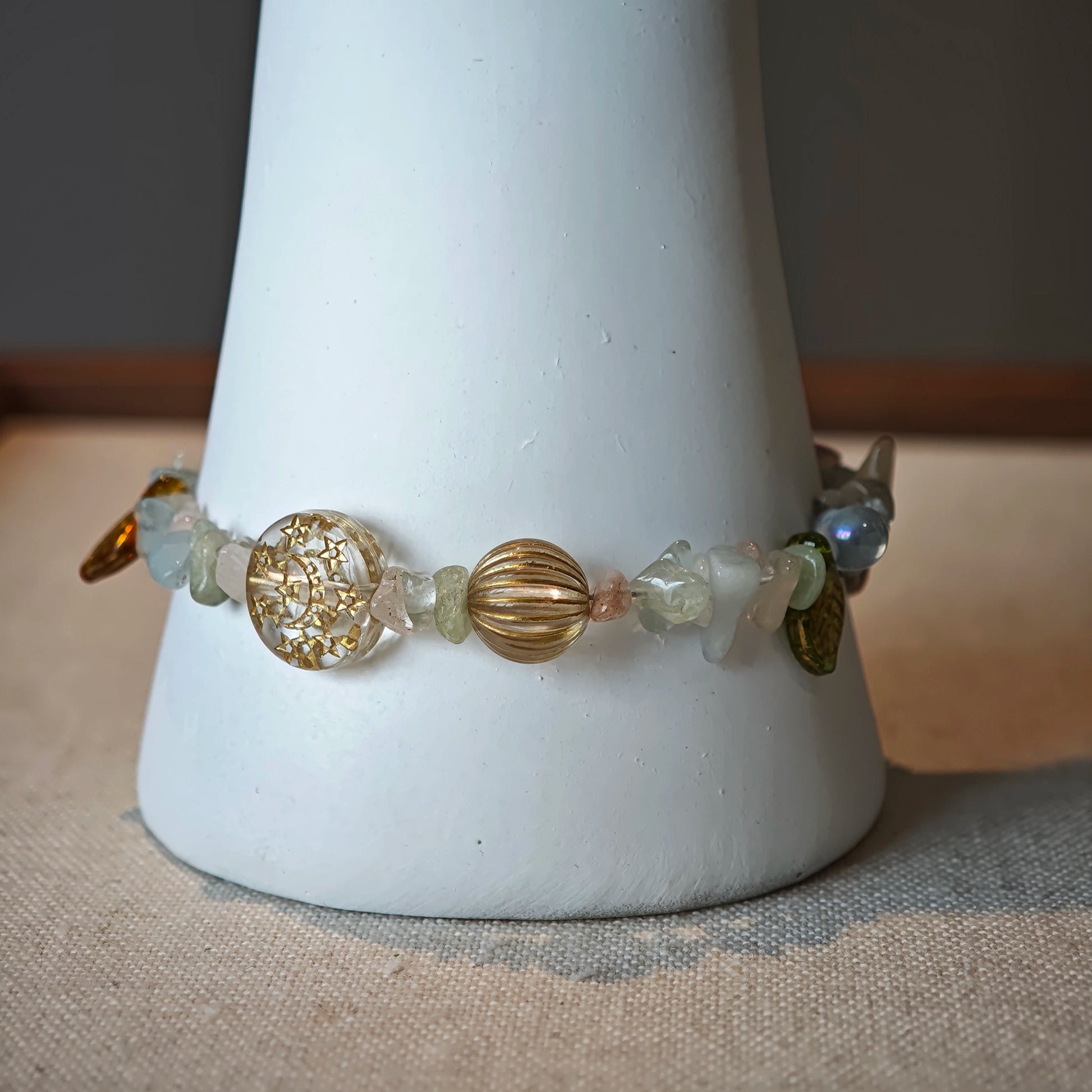Consist of milky white and pale blue glass beads and shimmering crystal fragments, this beaded bracelet glows like sunlight dancing on icy shores.