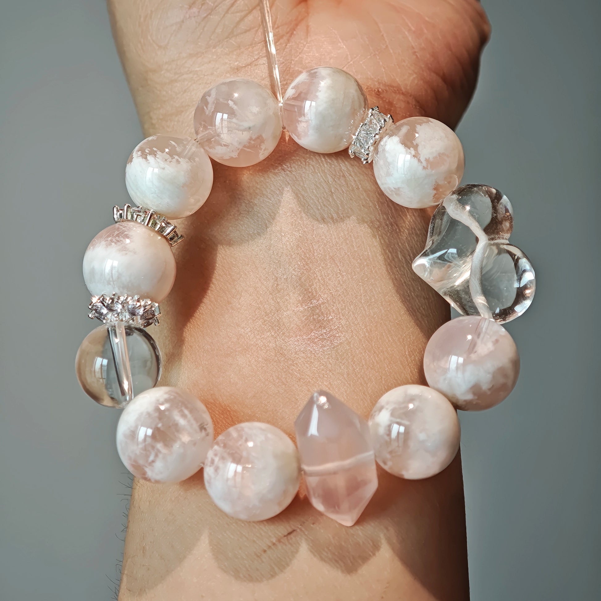 phantom rose quartz and flawless rock crystal unite in one strand, stirring the quiet longings of your heart.