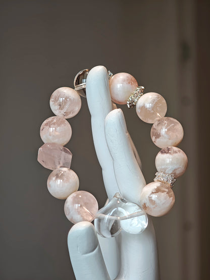 Wear a winter sunrise: phantom rose quartz for warmth, clear quartz for direction, both conspiring to unveil your truth.