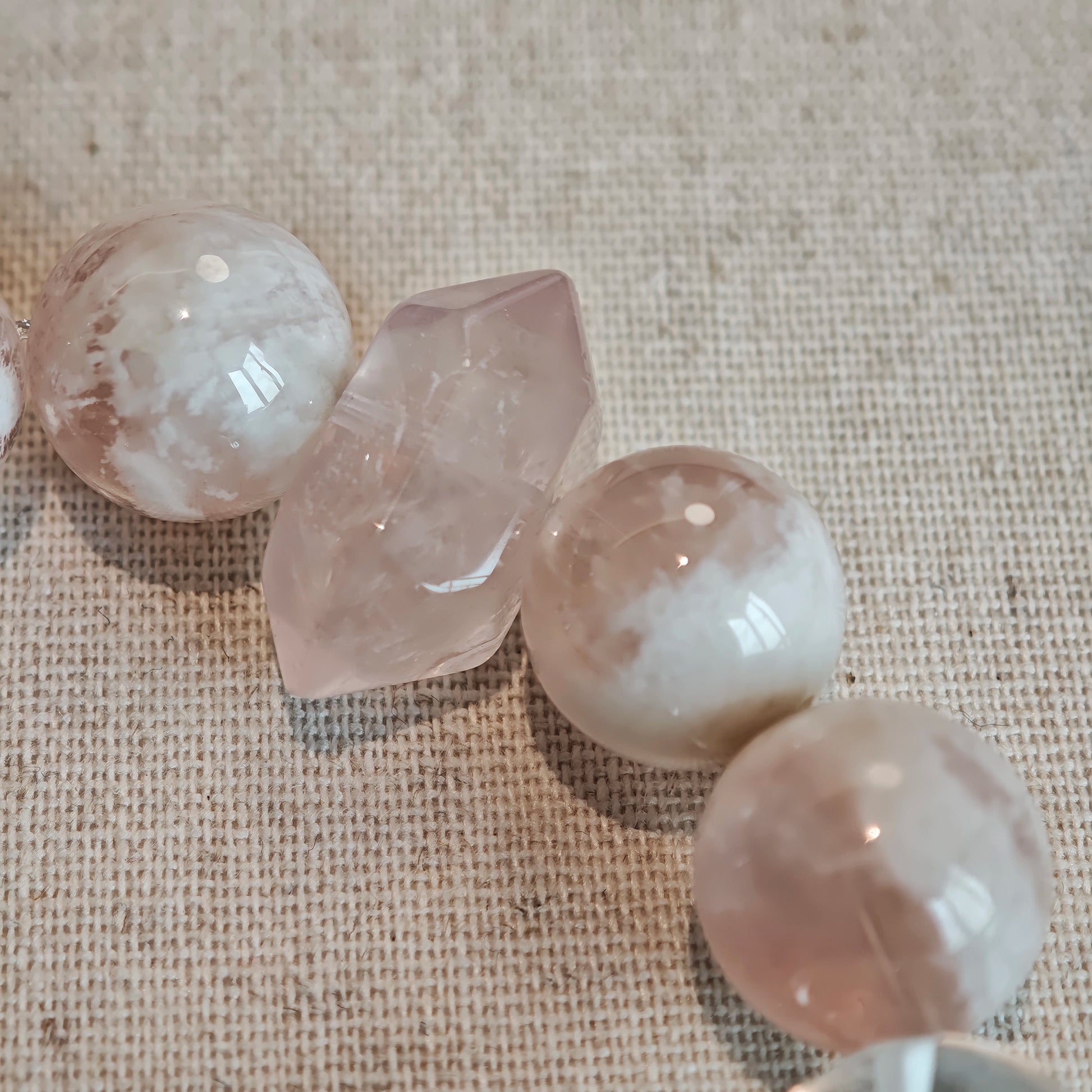 Blush phantoms kiss clear facets, sparking the quiet embers of ambition and affection.