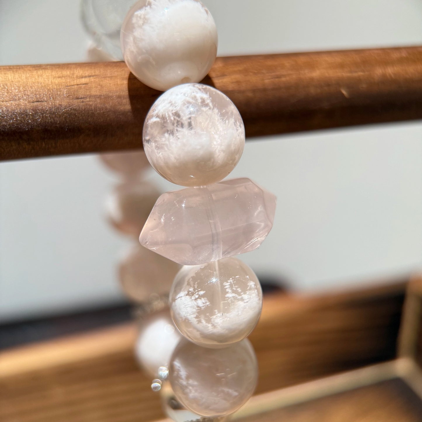 Gentle phantom rose quartz flakes float in rose mist, anchored by clear quartz—your soul’s wish-list in gem form.