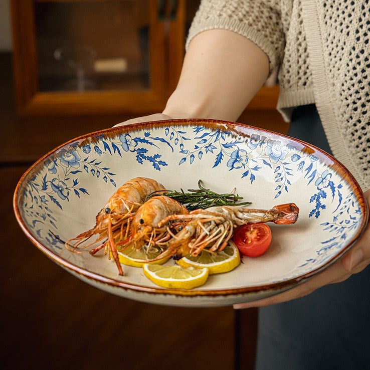 This is a 9-inch/23.5cm deep plate with blue lotus leaf patterns. The capacity is 920ml. And it's with wide and open shape. Crafted using a reactive "Kiln Change" glaze technique, each plate reacts differently to the high heat of the kiln.
