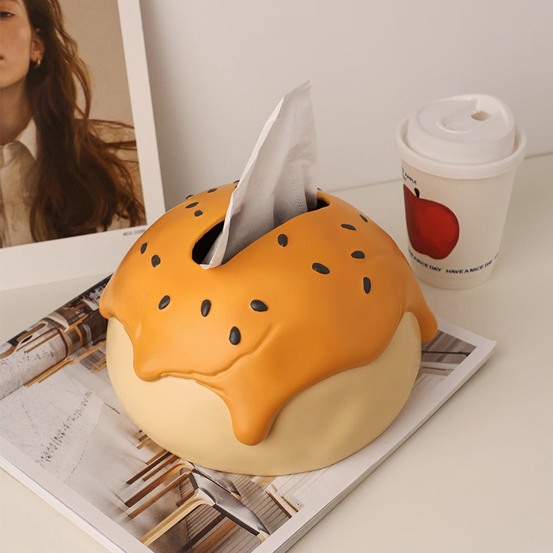 This is tissue box cover with an egg yolk pastry shape. On the lifelike flaky pstry surface, there are sesame seeds and a wide enough opening for pulling out tissues.