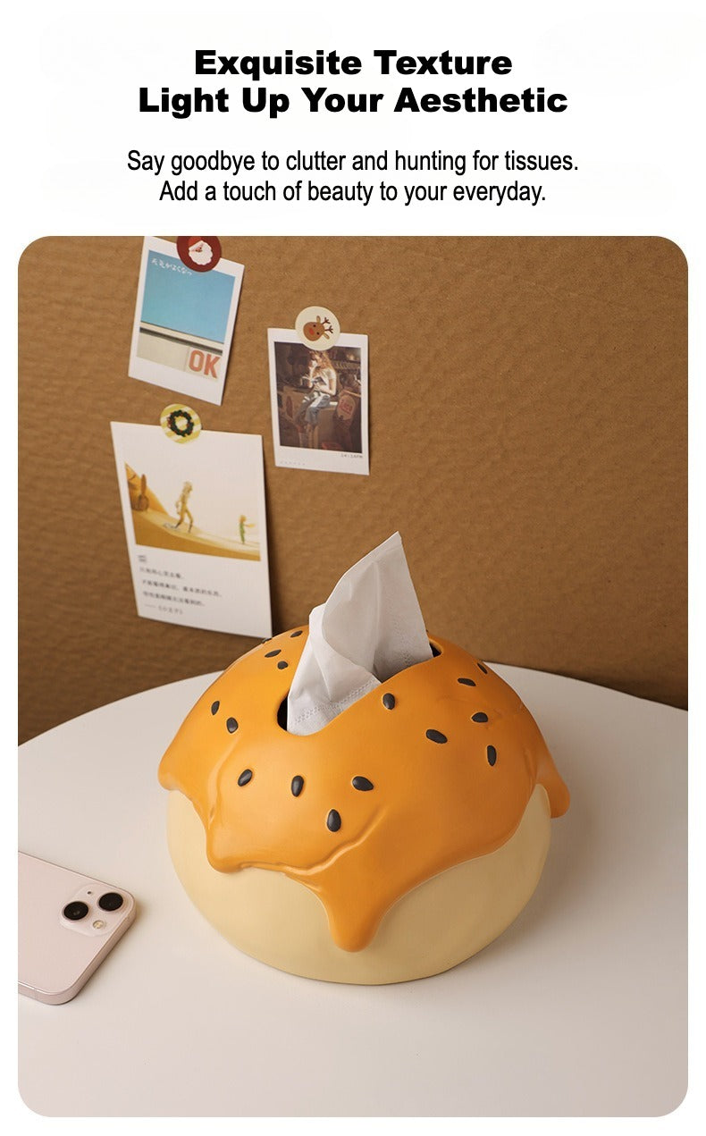 This is tissue box cover with an egg yolk pastry shape. On the lifelike flaky pstry surface, there are sesame seeds and a wide enough opening for pulling out tissues.