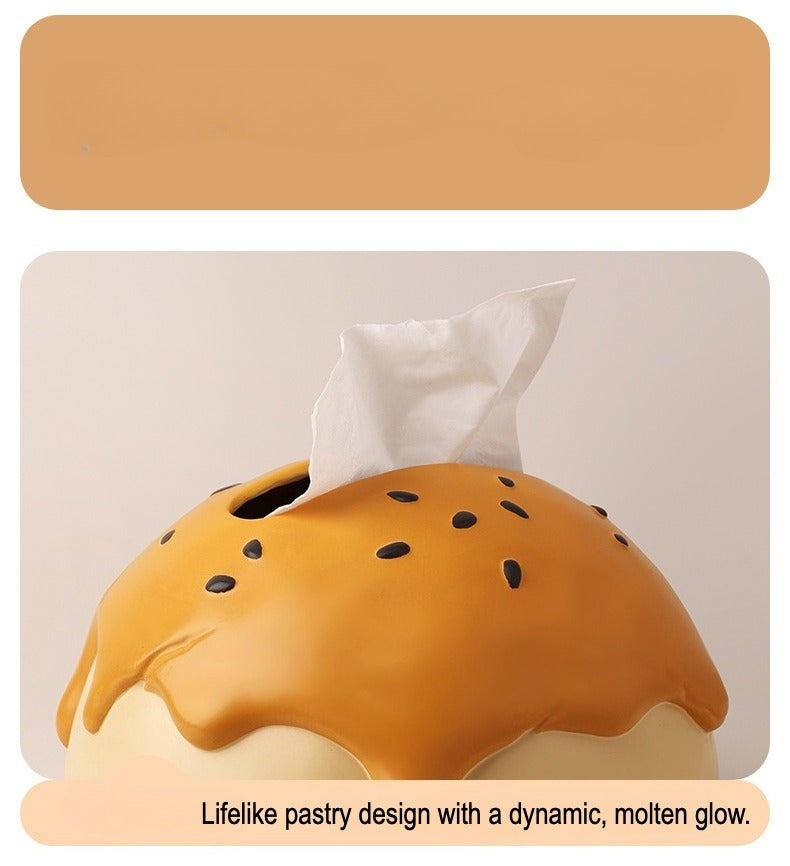 This is tissue box cover with an egg yolk pastry shape. On the lifelike flaky pstry surface, there are sesame seeds and a wide enough opening for pulling out tissues.