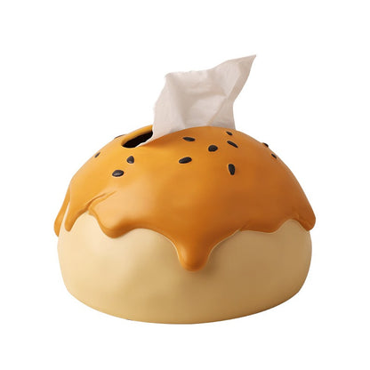 This is tissue box cover with an egg yolk pastry shape. On the lifelike flaky pstry surface, there are sesame seeds and a wide enough opening for pulling out tissues.
