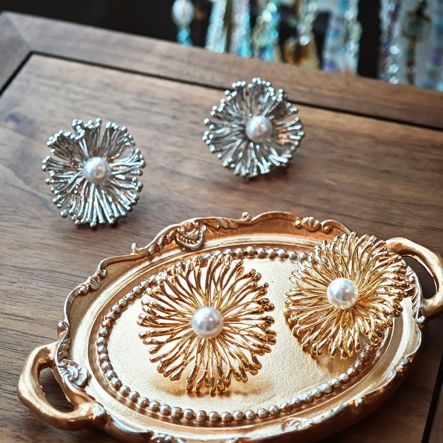 These earrings perfectly blend delicate flowers with lustrous pearls, exuding timeless romance and adding an elegant touch to any outfit.