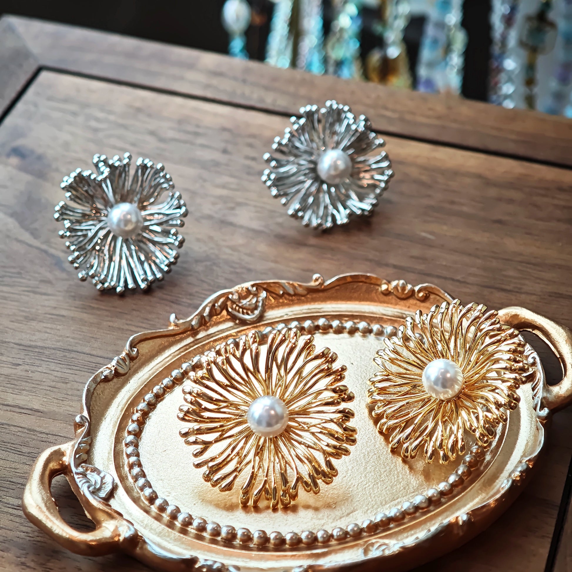 These earrings perfectly blend delicate flowers with lustrous pearls, exuding timeless romance and adding an elegant touch to any outfit.