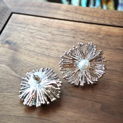 These earrings perfectly blend delicate flowers with lustrous pearls, exuding timeless romance and adding an elegant touch to any outfit.