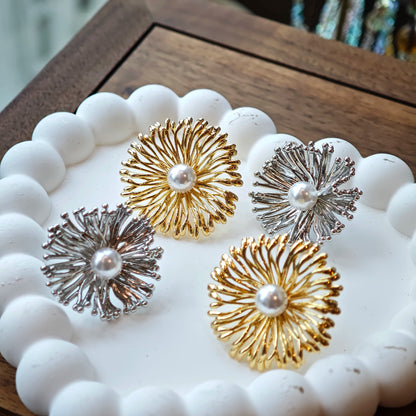 These earrings perfectly blend delicate flowers with lustrous pearls, exuding timeless romance and adding an elegant touch to any outfit.