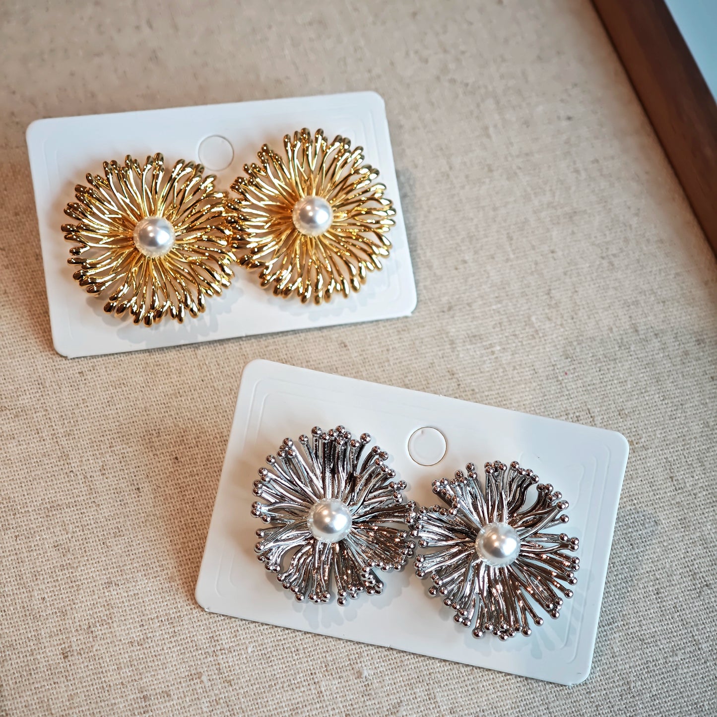 These earrings perfectly blend delicate flowers with lustrous pearls, exuding timeless romance and adding an elegant touch to any outfit.