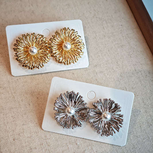 These earrings perfectly blend delicate flowers with lustrous pearls, exuding timeless romance and adding an elegant touch to any outfit.