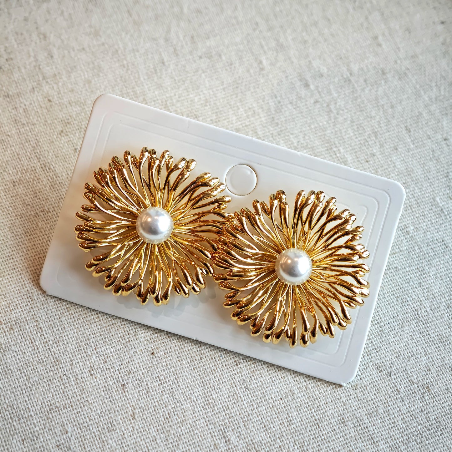 These earrings perfectly blend delicate flowers with lustrous pearls, exuding timeless romance and adding an elegant touch to any outfit.