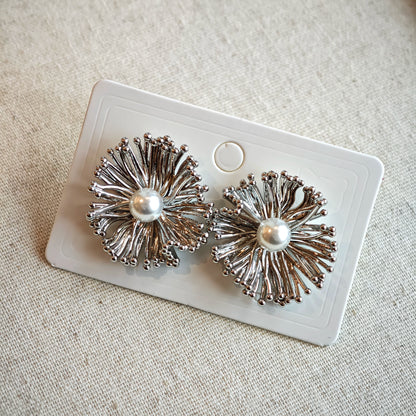 These earrings perfectly blend delicate flowers with lustrous pearls, exuding timeless romance and adding an elegant touch to any outfit.