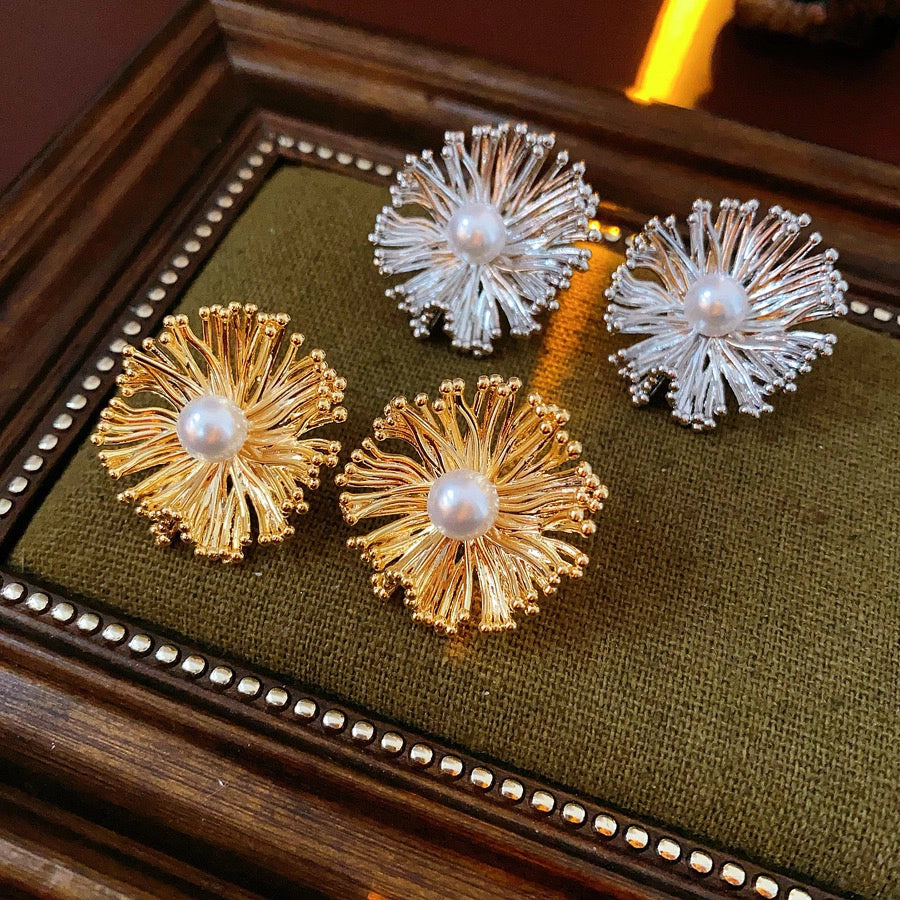 These earrings perfectly blend delicate flowers with lustrous pearls, exuding timeless romance and adding an elegant touch to any outfit.