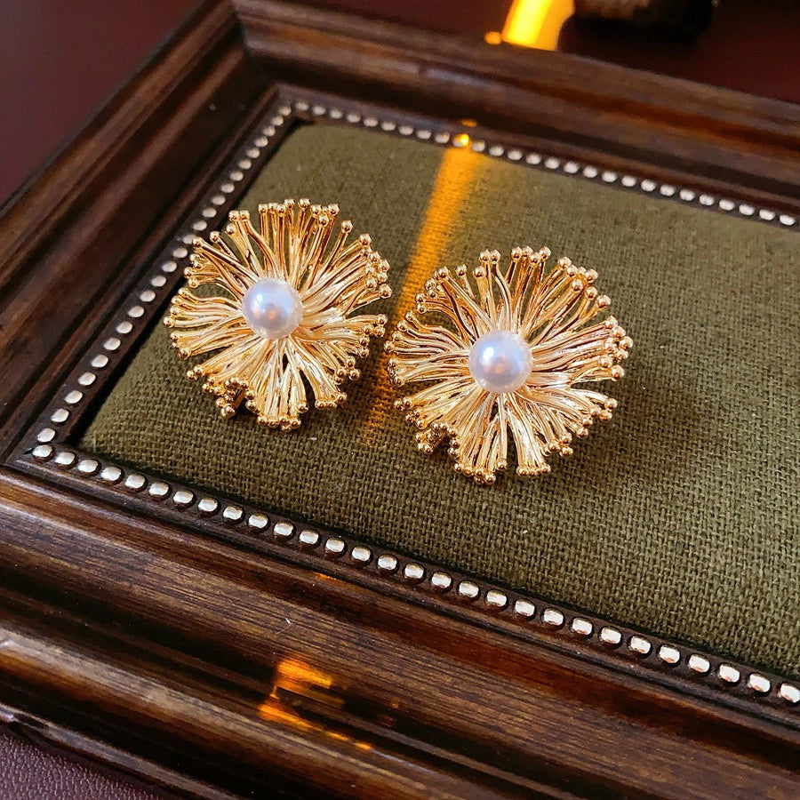 These earrings perfectly blend delicate flowers with lustrous pearls, exuding timeless romance and adding an elegant touch to any outfit.