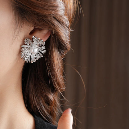 These earrings perfectly blend delicate flowers with lustrous pearls, exuding timeless romance and adding an elegant touch to any outfit.