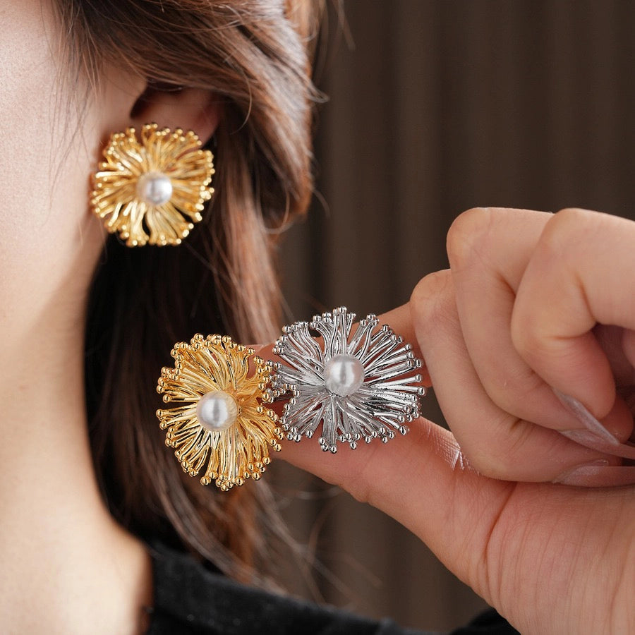 These earrings perfectly blend delicate flowers with lustrous pearls, exuding timeless romance and adding an elegant touch to any outfit.