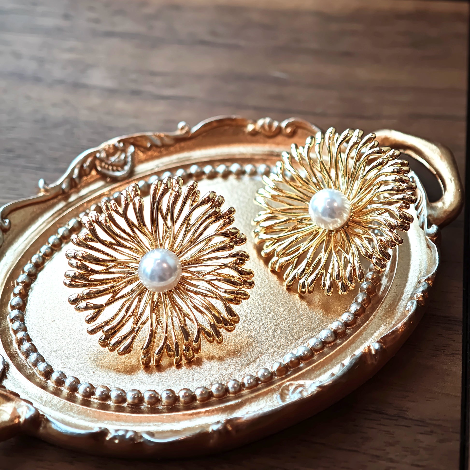 These earrings perfectly blend delicate flowers with lustrous pearls, exuding timeless romance and adding an elegant touch to any outfit.