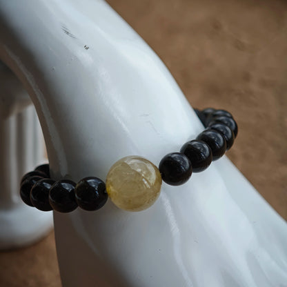 Feel the shield: gold-sheen obsidian, silver-sheen obsidian, rutile sparkle, and an oriental sandalwood-black agate charm.