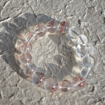 This is a golden strawberry quartz and Clear Quartz bracelet, with unique transparency and elegance.