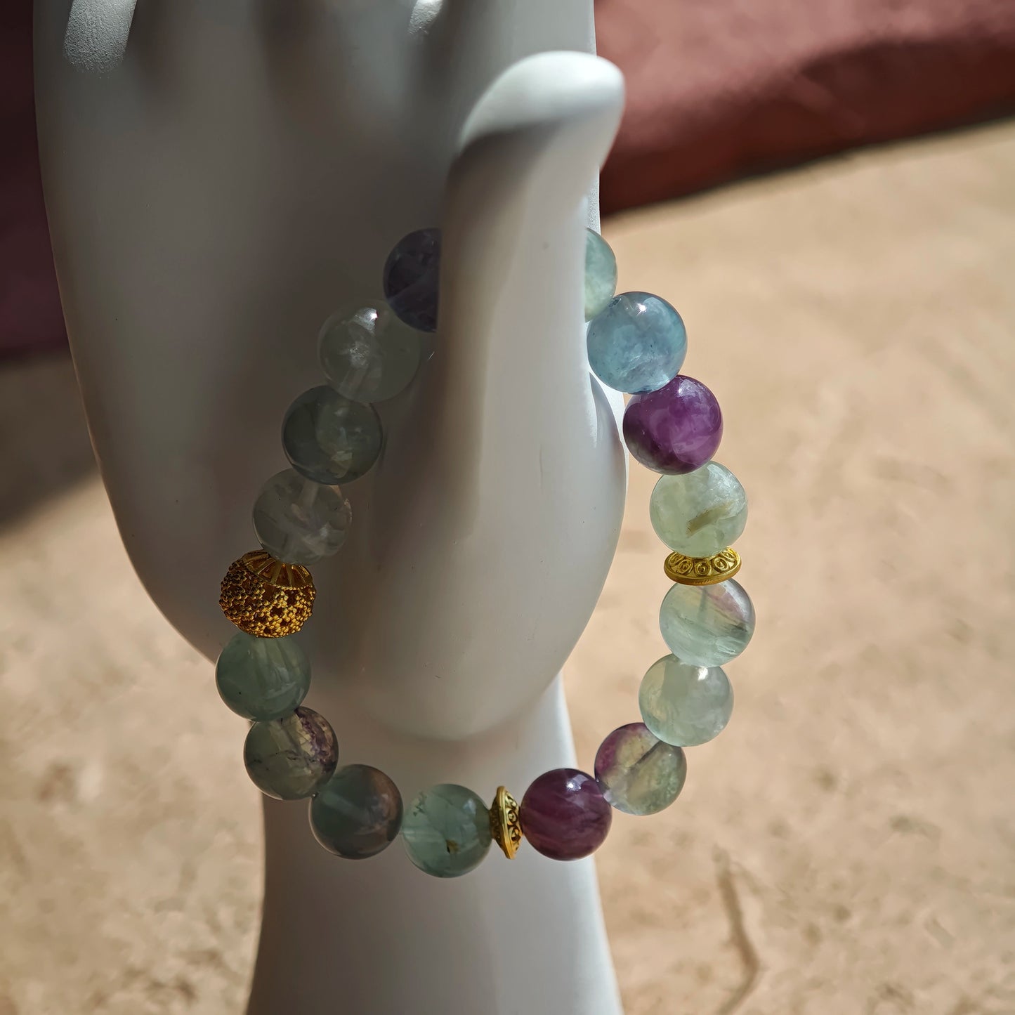 This is a natural green fluorite bracelet with gold-plated spacers. The color of each bead is different.