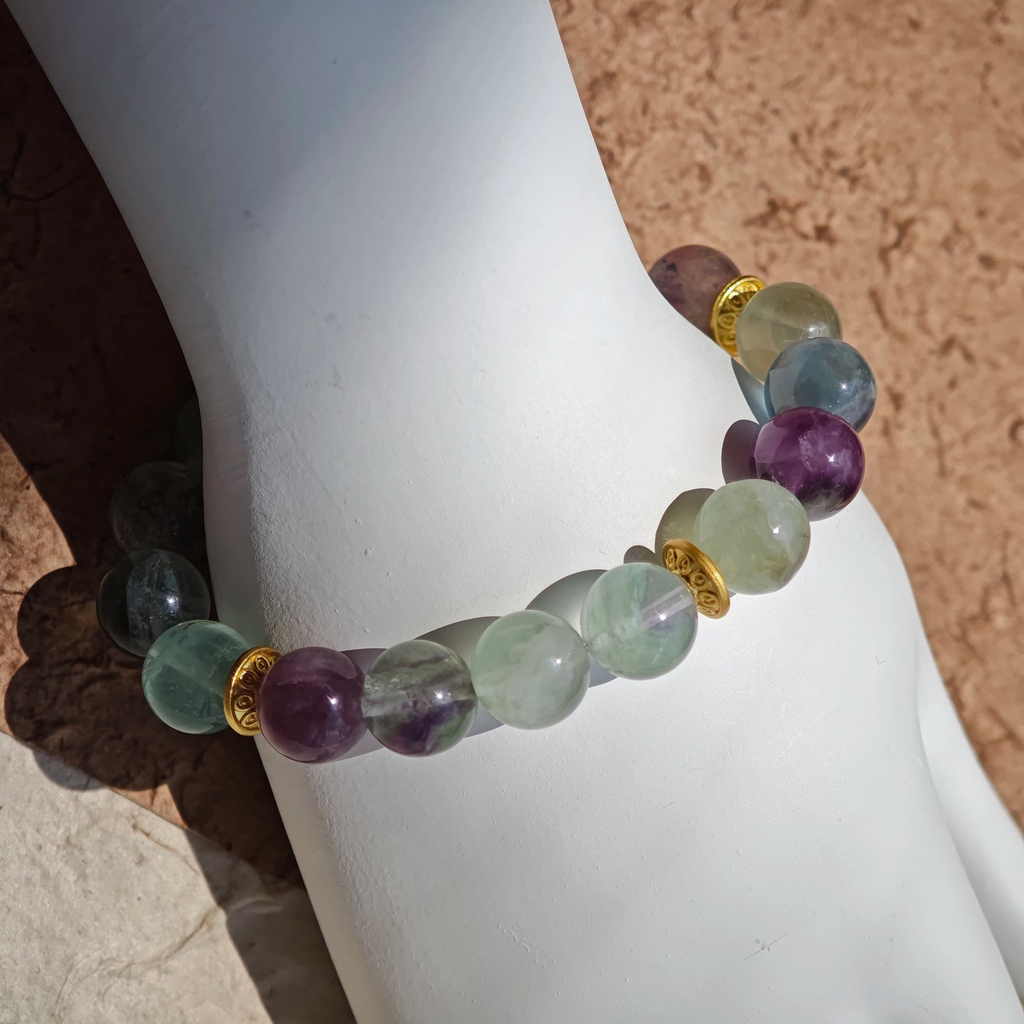 This is a natural green fluorite bracelet with gold-plated spacers. The color of each bead is different.