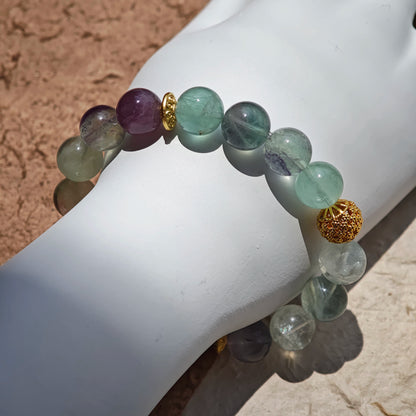 This is a natural green fluorite bracelet with gold-plated spacers. The color of each bead is different.