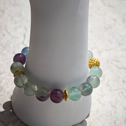 This is a natural green fluorite bracelet with gold-plated spacers. The color of each bead is different.