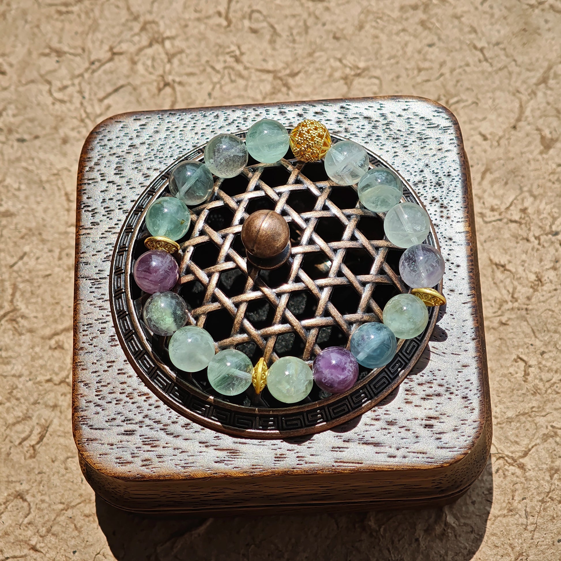 This is a natural green fluorite bracelet with gold-plated spacers. The color of each bead is different.