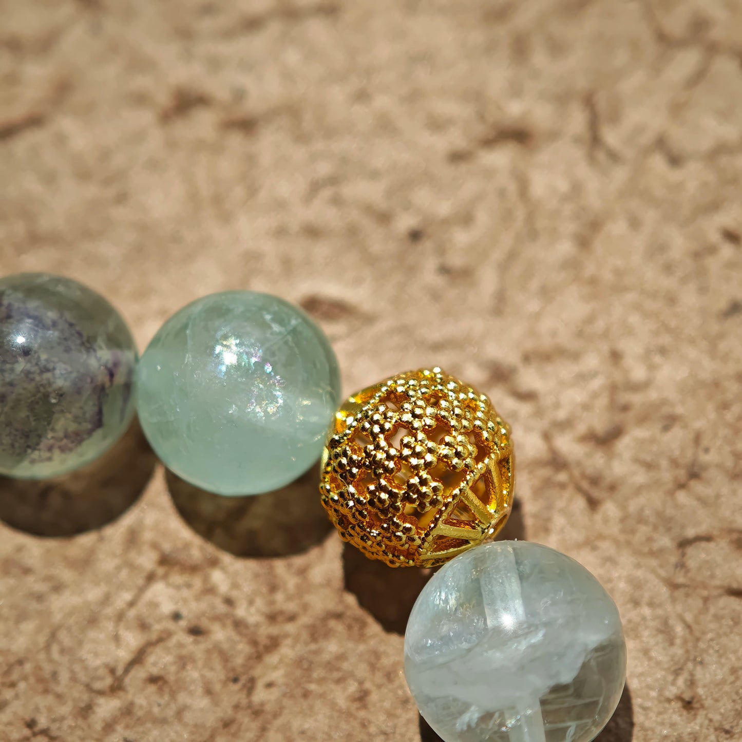 This is a natural green fluorite bracelet with gold-plated spacers. The color of each bead is different.