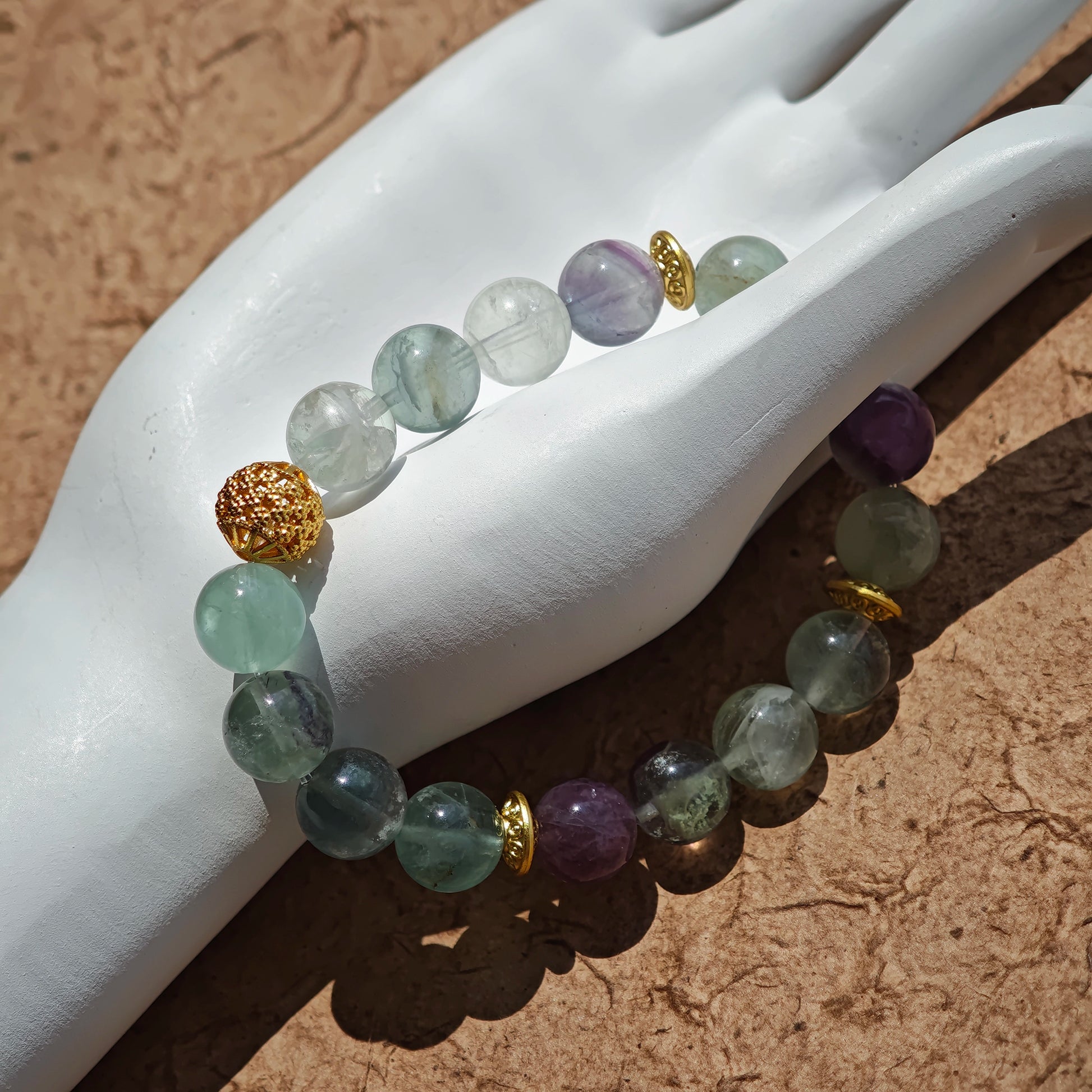 This is a natural green fluorite bracelet with gold-plated spacers. The color of each bead is different.