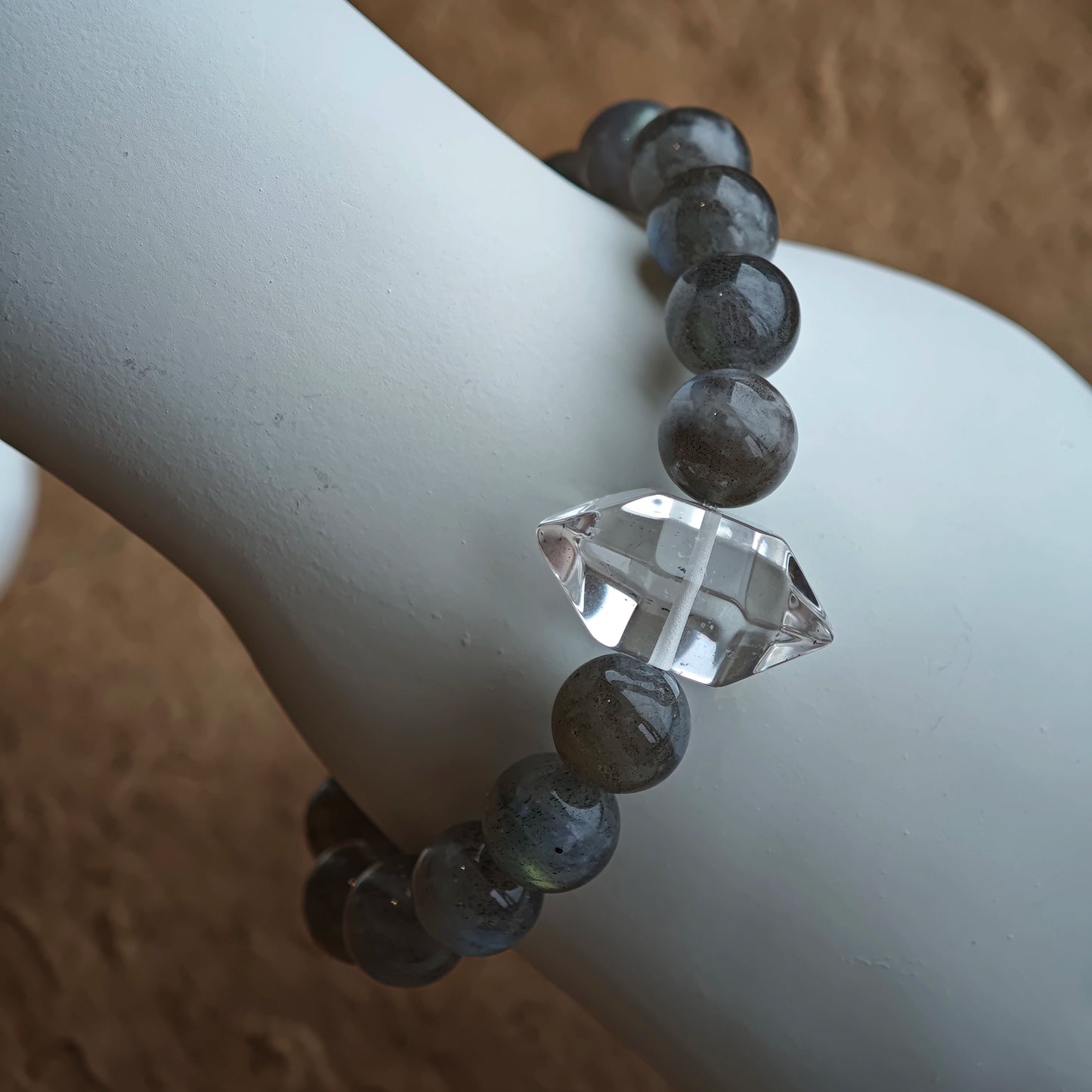 This grey moonstone bracelet consists of 17 grey moonstone and 1 clear quartz. It's mystery and elegant.