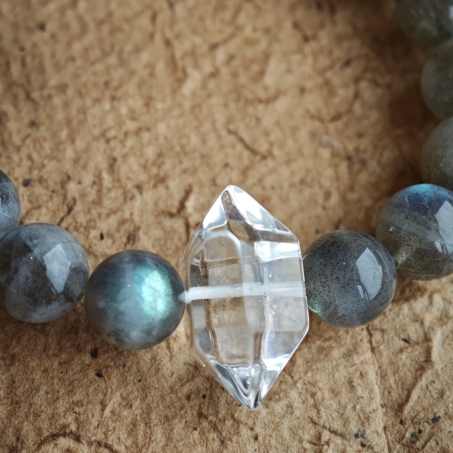 This grey moonstone bracelet consists of 17 grey moonstone and 1 clear quartz. It's mystery and elegant.