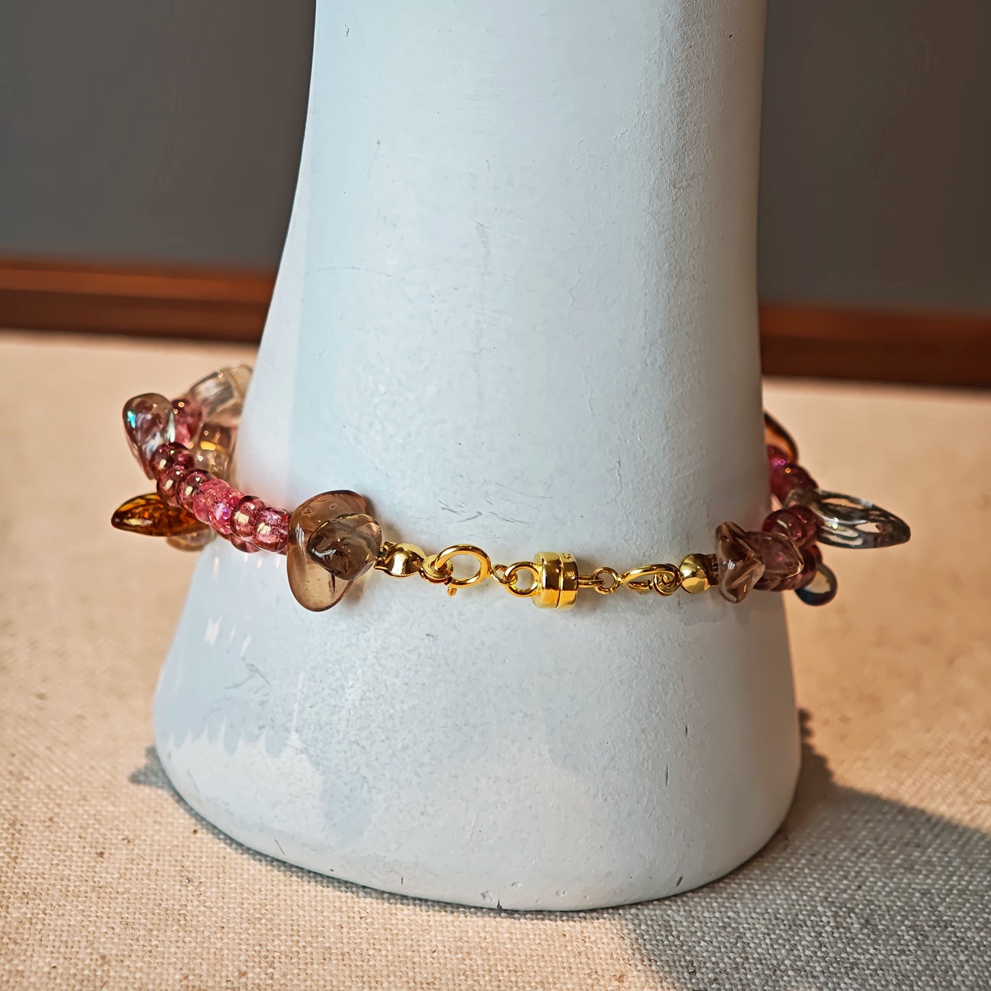 This is a pink czech beads bracelet, decorated with green leaves , yellow lemon, flowers and irregularly shape amber color beads.