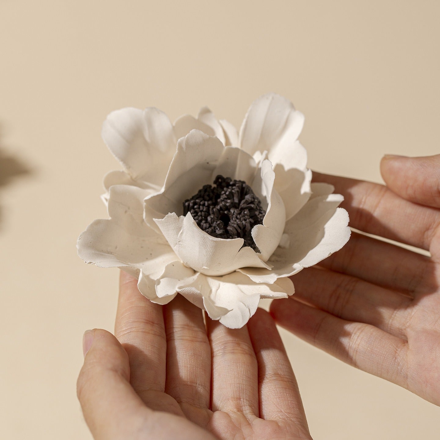 This is a ceramic flower incense stick holder with a lifelike flower. Each ceramic flower is individually hand-shaped using traditional ceramic craftsmanship. The ceramic flower is with diameter of 8cm and height of 4.3cm.