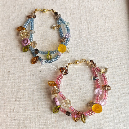 This bracelet features shimmering Czech glass beads in beautiful shades of blue, all hand-strung on a delicate double chain. An 18k gold-plated magnetic clasp makes it super easy to wear, and it's designed for a 15cm wrist.