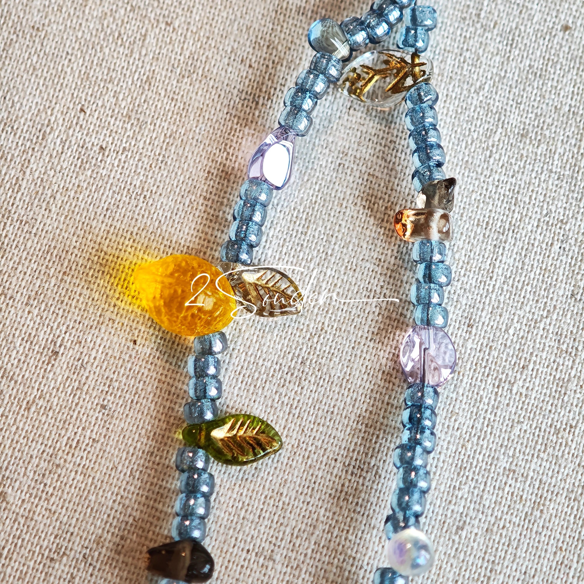 This bracelet features shimmering Czech glass beads in beautiful shades of blue, all hand-strung on a delicate double chain. An 18k gold-plated magnetic clasp makes it super easy to wear, and it's designed for a 15cm wrist.