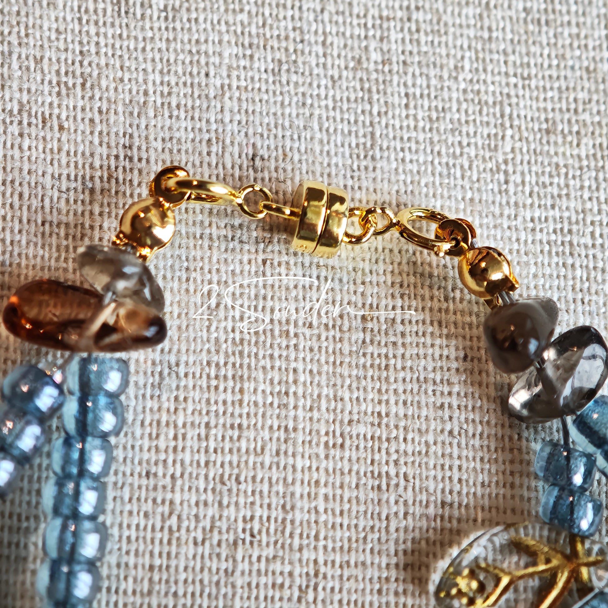 This bracelet features shimmering Czech glass beads in beautiful shades of blue, all hand-strung on a delicate double chain. An 18k gold-plated magnetic clasp makes it super easy to wear, and it's designed for a 15cm wrist.