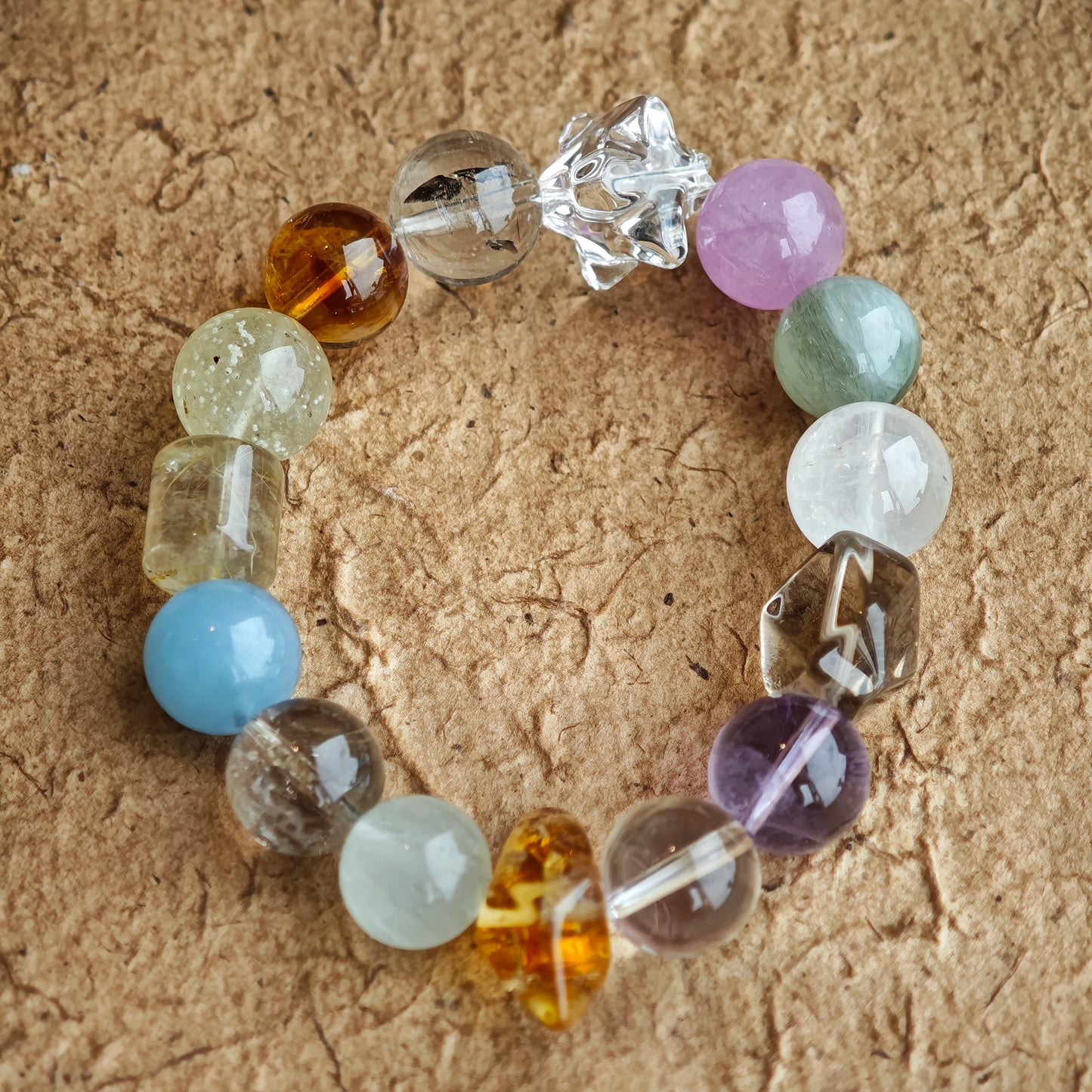 Harmony Treasures: 13-13.8 mm beads blend sea-blue aquamarine, royal amethyst, golden citrine, soft green prehnite, and cloud-white phantom quartz into one fluid palette.
