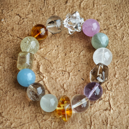 Harmony Treasures: 13-13.8 mm beads blend sea-blue aquamarine, royal amethyst, golden citrine, soft green prehnite, and cloud-white phantom quartz into one fluid palette.