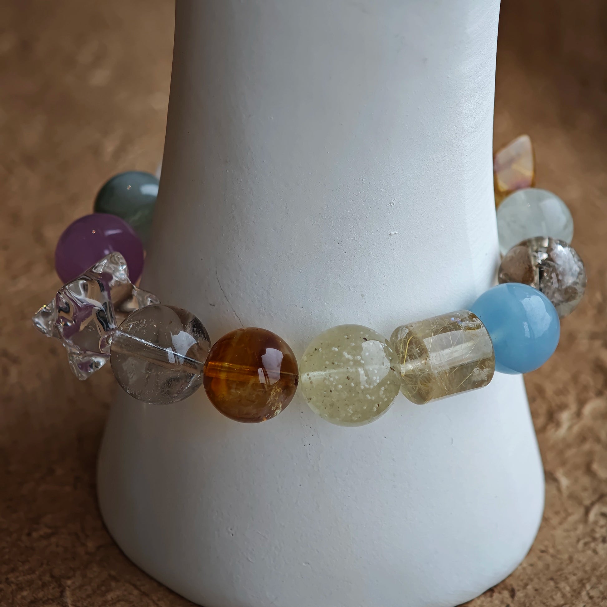 Colors melt into one another—cool marine, deep violet, honey light, sage green, pearly haze.